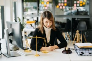 Asian lawyer woman working with a laptop and tablet in a law office. Legal and legal service concept