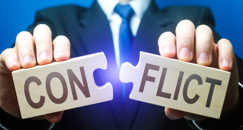 Man breaks puzzles with word Conflict. Resolution of disputes and conflicts in negotiations. Come to