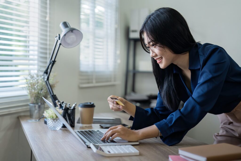 Woman on desk with laptop, credit card and ecommerce payment for online shopping at home. digital